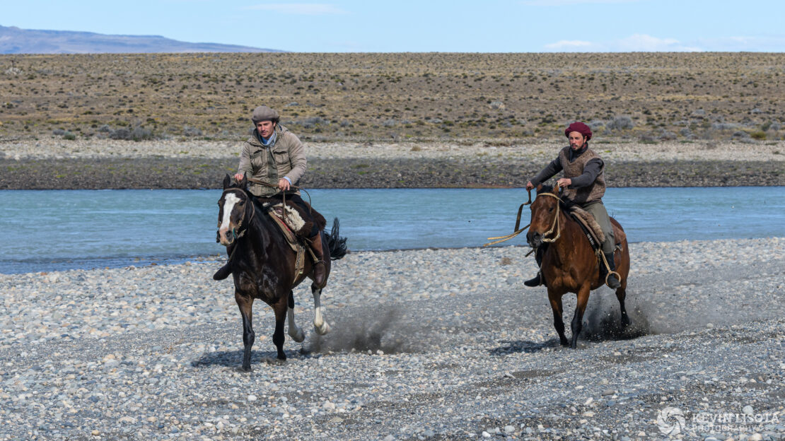 Gauchos on horseback along the La Leona River of Patagonia